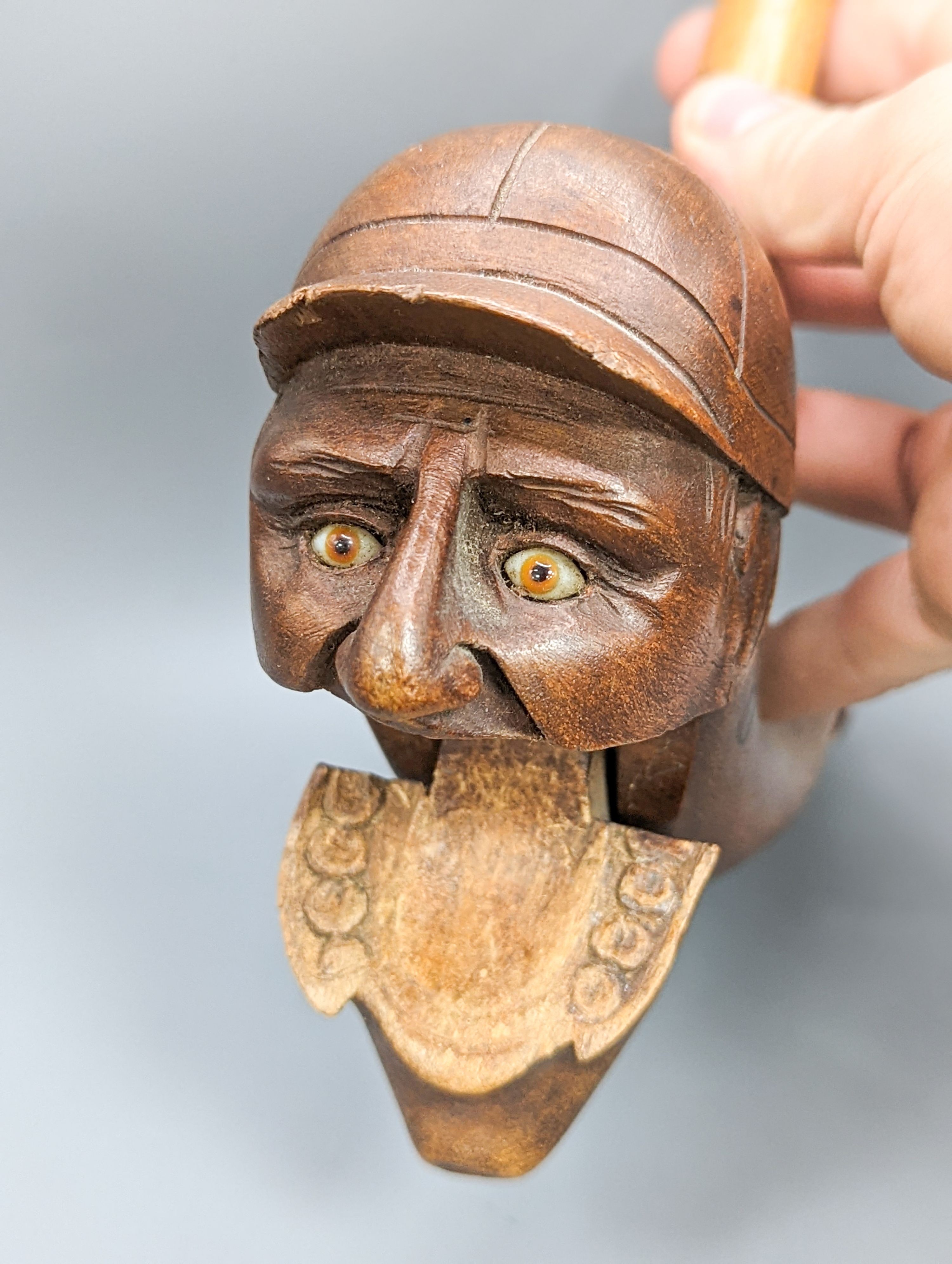 A pair of Victorian treen nutcrackers, in the form of a jockey’s head, glass in set eyes, length 20cm